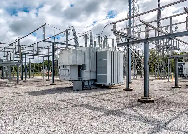 Electrical substation with transformers and power lines for energy distribution.